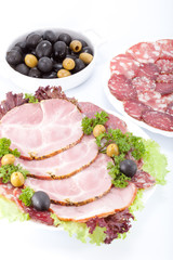 Cutting sausage and meat on a celebratory table.