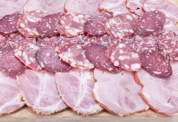 Cutting sausage and meat on a celebratory table.