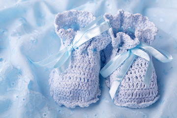 Blue baby booties on blue background