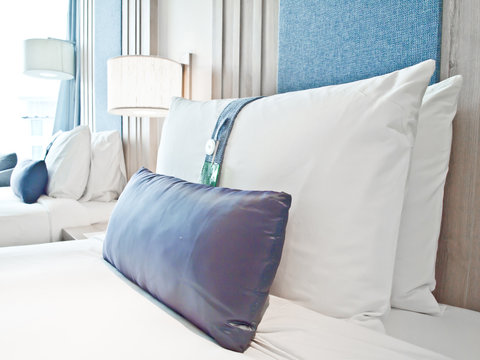a pillows on beds in a luxury hotel room