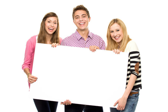 Friends holding blank poster