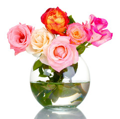 Beautiful bouquet of roses in transparent vase isolated on white