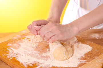 cooking dough on brown background