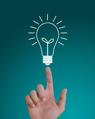 hand pointing to idea light bulb on top.