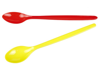 Red and yellow shiny plastic spoons with long handles isolated o