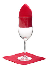 Wine glass with red festive or Christmas napkins, isolated on wh