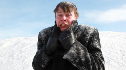 The man all in snow is shivering, seems that he was cold
