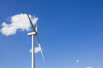 white wind turbine generating electricity on blue sky