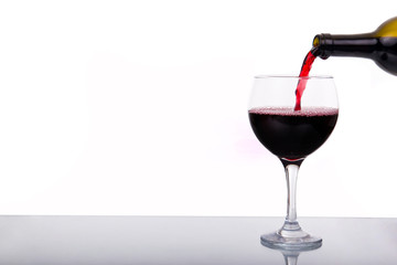Red wine pouring into wine glass