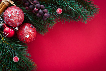 christmas card with baubles and fir tree on red