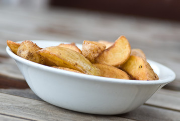 A bowl of baked potato wedges