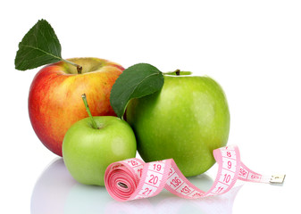 Concept of a diet. Many fresh ripe apples with measuring tape