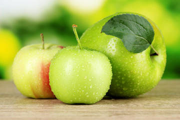 Fresh organic apples on wooden table isolated on white