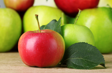 Many fresh organic apples on wooden table