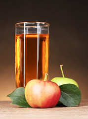 Glass of healthy fresh juice of apples on brown background
