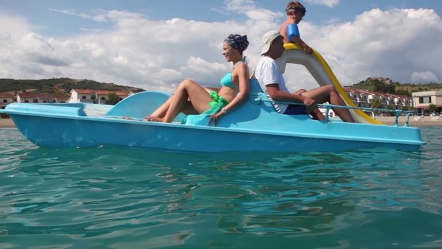 Father, mother and their son sailing on catamaran