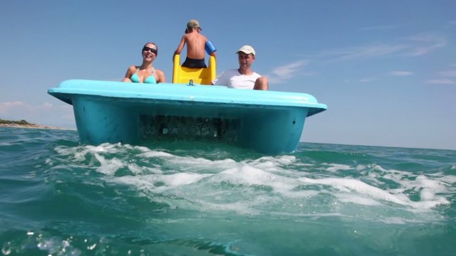 Father, mother and their son sailing on catamaran