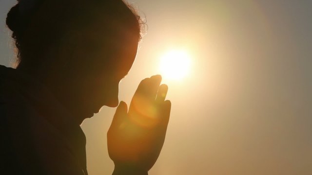 Silhouette of woman head, she is praying