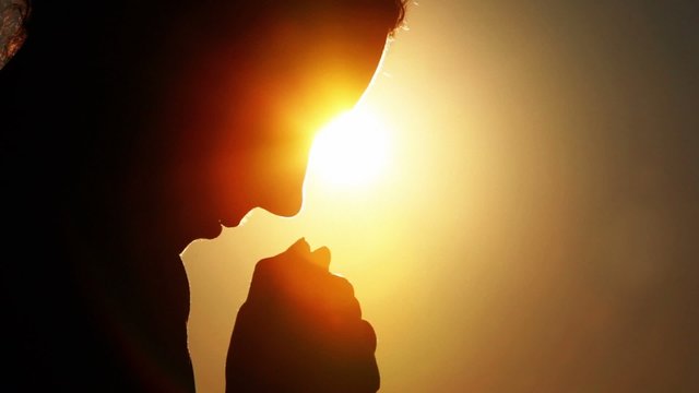 woman head, holding two fists together and bowed head