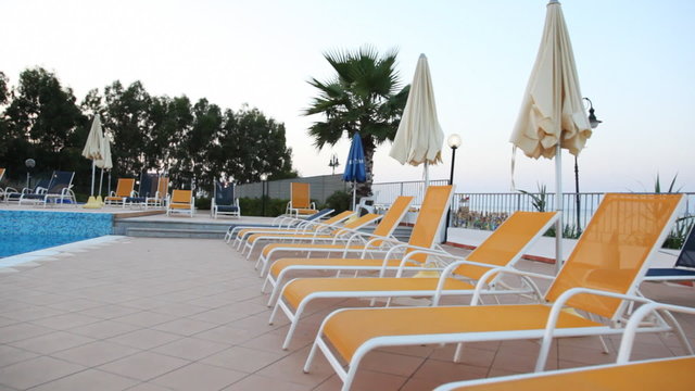 Beach beds and sunshades by pool