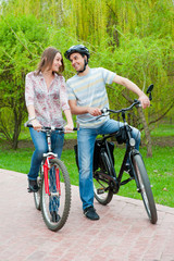 Fototapeta na wymiar Happy young couple riding bicycles
