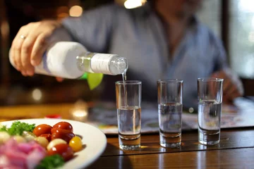 Foto op Plexiglas Man pouring vodka in pub © Arkady Chubykin