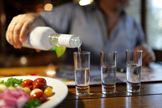 Man pouring vodka in pub