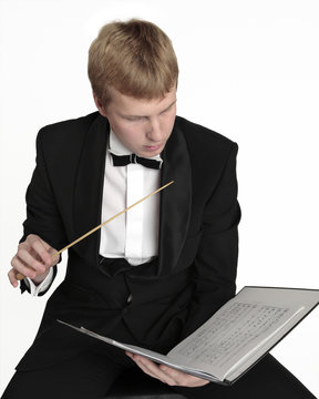 Conductor with score and baton in hands
