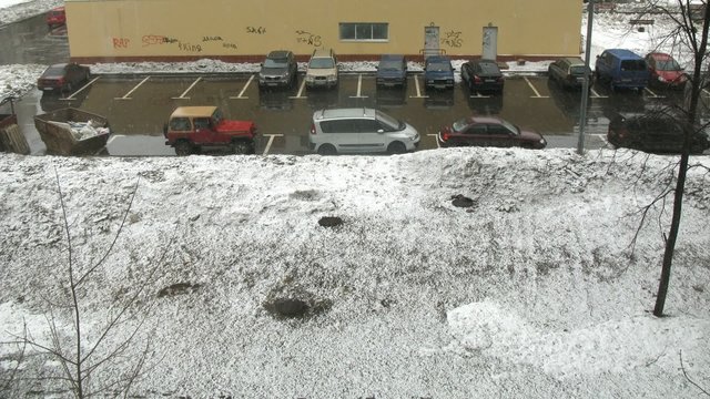 Parking in city during snow storm, view from window