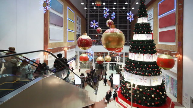 People move near Christmas tree in shopping mall