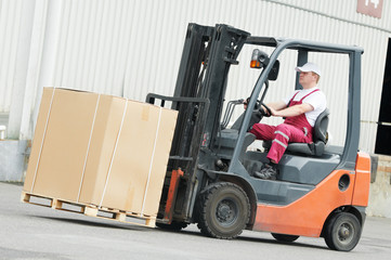 warehouse worker driver in forklift
