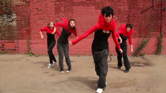 Dance team of four girls start dance synchronously