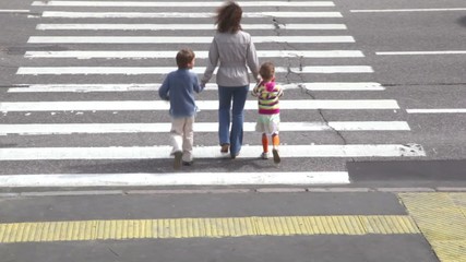 Mother and children, cross road at pedestrian crossing - Powered by Adobe