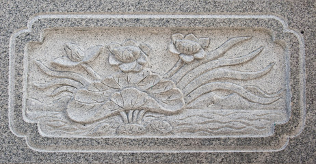 Stone carved in lotus form on the water at chinese temple in Tha
