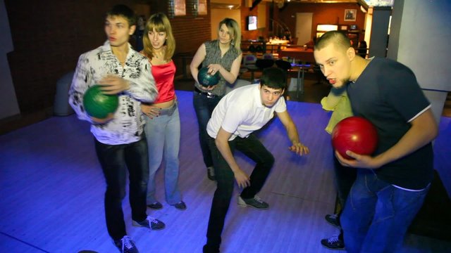 Company stay in bowling club and rejoice to success of friend