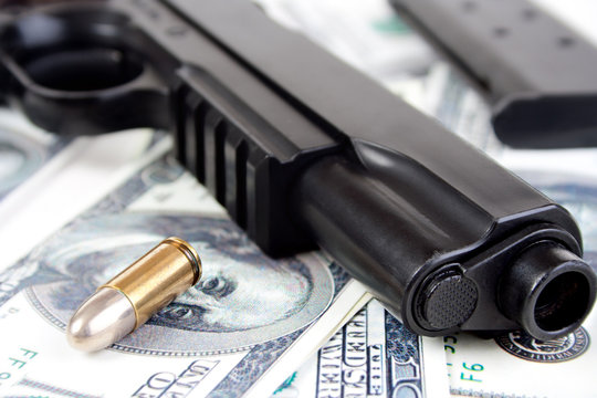 9mm bullet and handgun with money