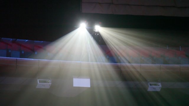 Two projectors shine white light under ceiling