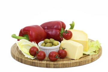 yellow cheese with fresh vegetables isolated on white background