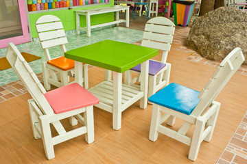four colorful chairs and a table