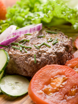 hamburger with slice vegetables over cutting board