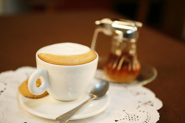 sweet cappuccino, a cup of cappuccino with syrup.