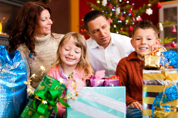 Fototapeta na wymiar Christmas - family with gifts on Xmas Eve