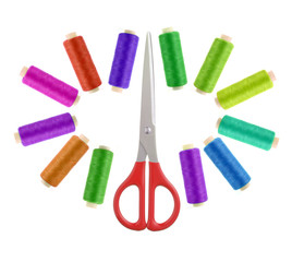scissors and multicolor sewing threads  isolated on white backgr