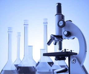 microscope and test tubes with liquid toning in blue color