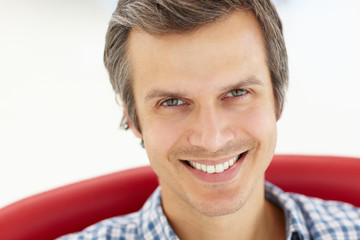 Fototapeta premium Man sitting in red chair