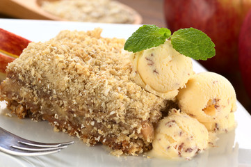 Apple crisp served with ice-cream and mint leaf
