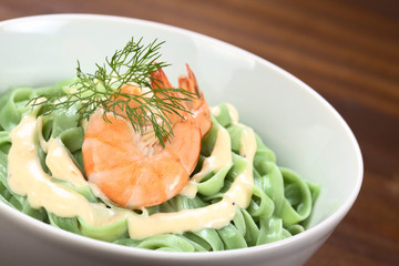 Green tagliatelle (ribbon noodle), cream sauce, shrimp, dill