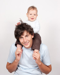 Baby sitting on father neck on white © huntun