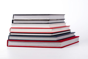 stack of colorful books on white