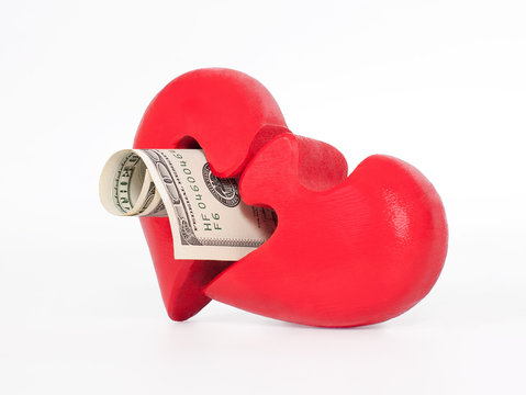 red puzzle heart and dollar on white